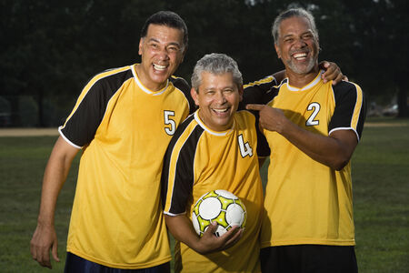 Multi-ethnic men holding soccer ballの写真素材
