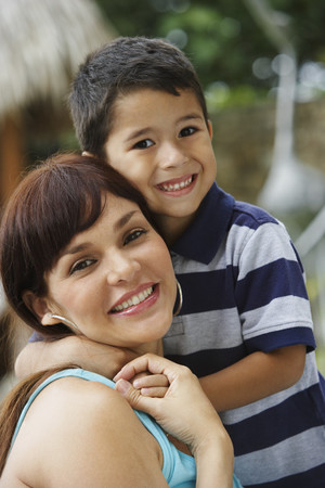 Hispanic mother and son huggingの写真素材