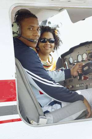 African couple in cockpit of airplaneの写真素材