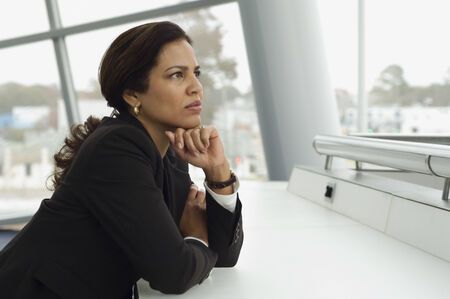 Hispanic businesswoman thinkingの写真素材