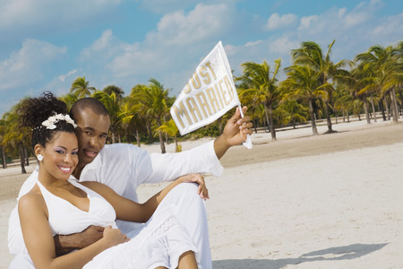 Multi-ethnic bride and groom at beachの写真素材