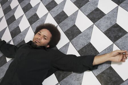 Mixed Race man laying on floorの写真素材