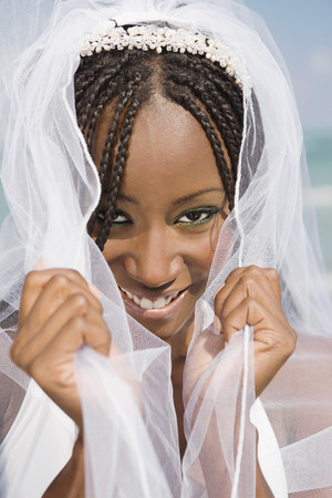 African bride pulling veil forwardの写真素材