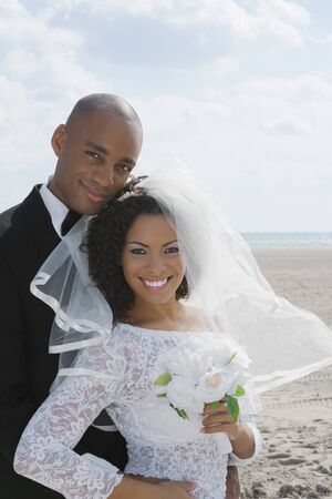 Multi-ethnic bride and groom huggingの写真素材