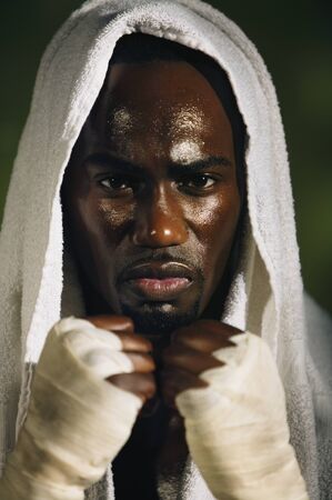 African male boxer with towel on headの写真素材