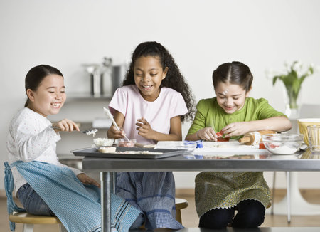 Multi-ethnic girls baking cookiesの写真素材