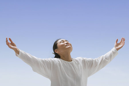 Asian woman with arms outstretchedの写真素材