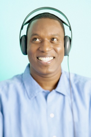 Mid adult man wearing headphones smilingの写真素材