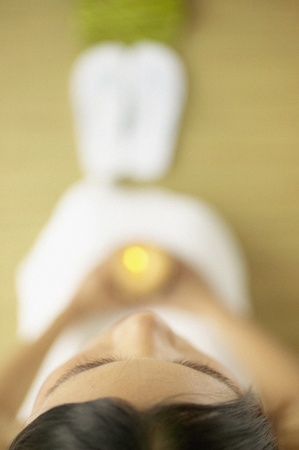 High angle view of young woman holding a lit candle