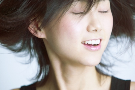 Young woman standing with her eyes closedの写真素材