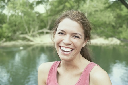 Young woman laughing outdoorsの写真素材