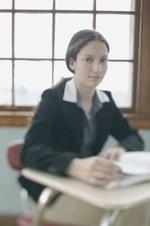 Portrait of a teenage girl in a classroomの写真素材