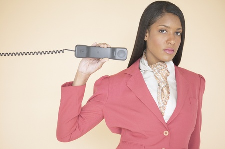 Woman holding a telephone receiverの写真素材