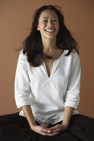 Asian woman sitting cross leggedの写真素材