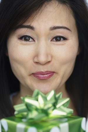 Asian woman holding giftの写真素材