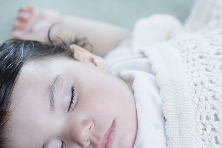 Close up of Hispanic baby sleepingの写真素材