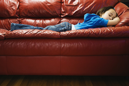 Asian girl sleeping on sofa