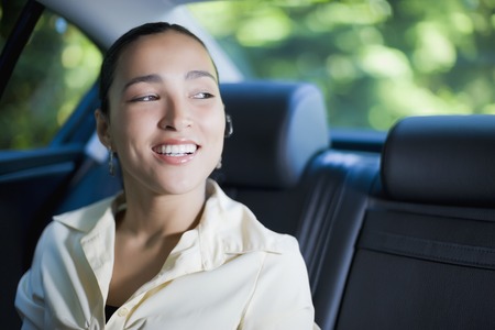 Hispanic businesswoman with hands-free cell phone deviceの写真素材