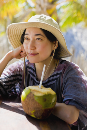 Japanese woman next to coconutの写真素材