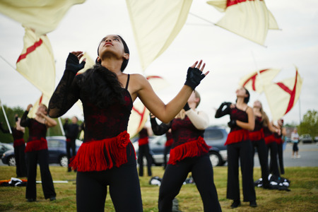 Flag twirlers performing on grass