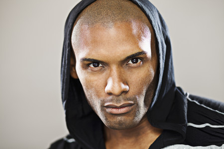 Serious Hispanic man wearing hoodyの写真素材