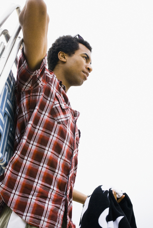 Mixed race man carrying lounge chairの写真素材