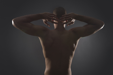 Mixed race athlete standing with arms raisedの写真素材