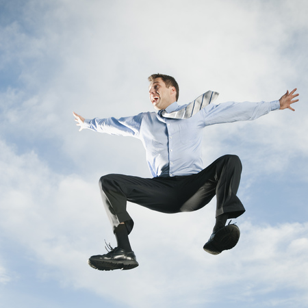 Caucasian businessman jumping in air