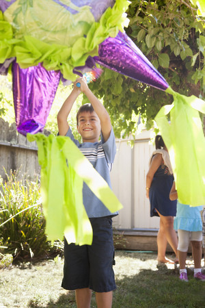 Hispanic boy trying to hit pinata