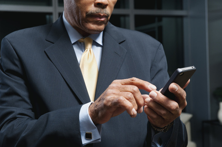 Black businessman using cell phoneの写真素材