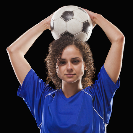 Caucasian soccer player holding ballの写真素材