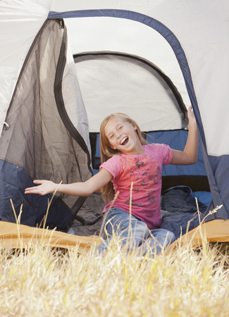 Caucasian girl sitting in tentの写真素材