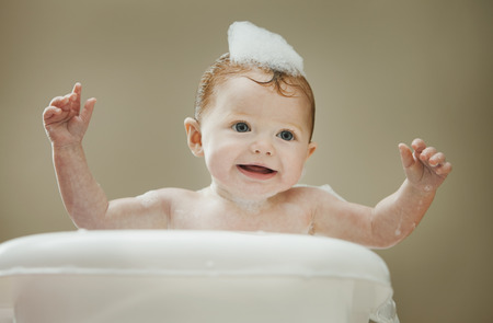 Caucasian baby girl having a bath