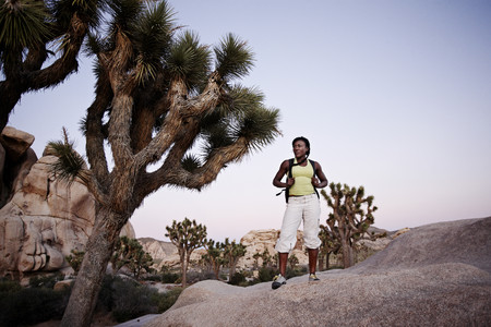 Woman hiking on large rockの写真素材