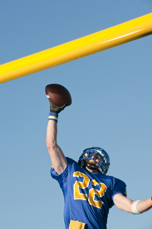 Caucasian football player catching ballの写真素材