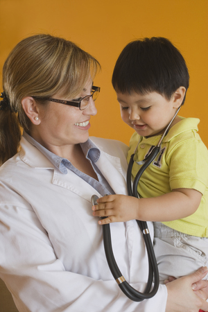 Hispanic doctor holding baby boyの写真素材