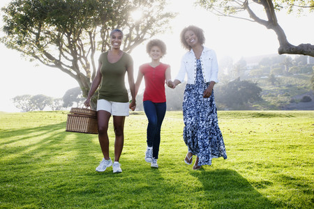 African American family walking in park