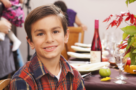 Smiling Hispanic boy at Thanksgiving dinnerの写真素材