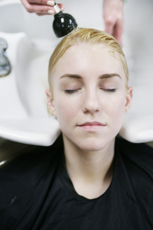 Woman having her hair washed in salon
