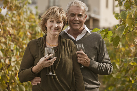 Caucasian couple drinking wine in vineyardの写真素材