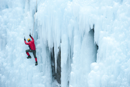 Caucasian man climbing ice wallの写真素材