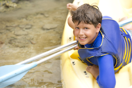 Hispanic boy sitting in canoeの写真素材