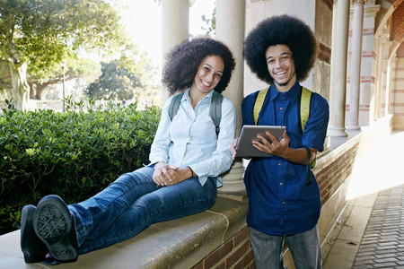 Mixed race college students with digital tabletの写真素材