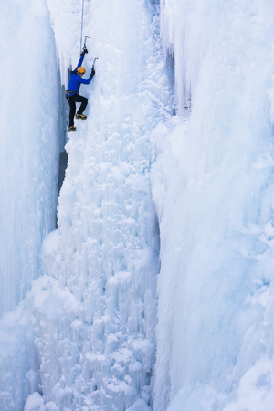 Caucasian climber scaling glacierの写真素材