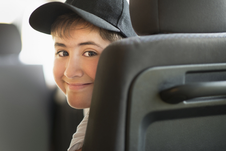 Hispanic boy smiling in carの写真素材