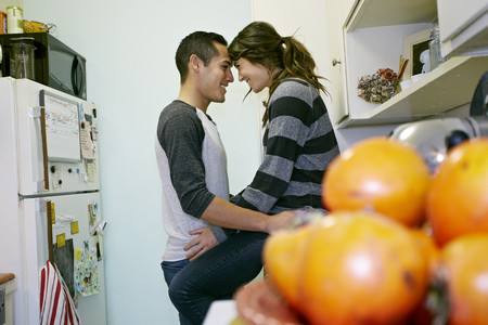 Smiling couple relaxing in kitchen