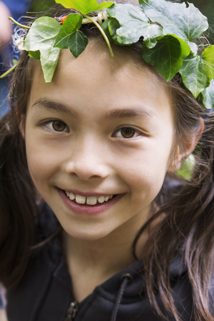Mixed race girl wearing ivy wreathの写真素材