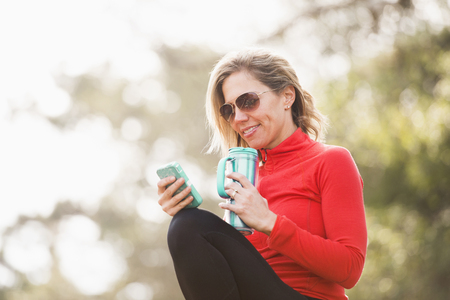 Caucasian woman using cell phone outdoorsの写真素材