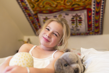 Caucasian girl smiling on sofaの写真素材