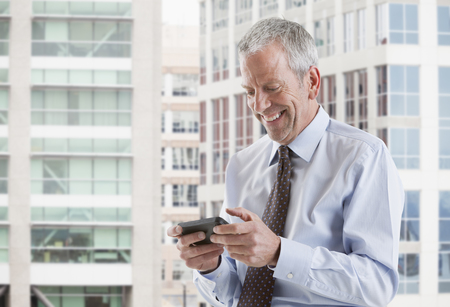 Caucasian businessman using cell phoneの写真素材